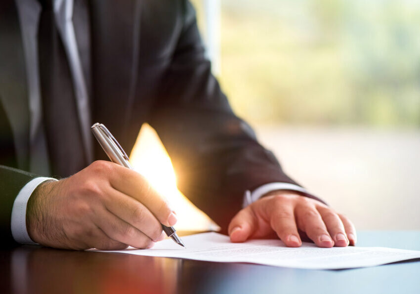 Businessman Is Signing A Legal Document In Office